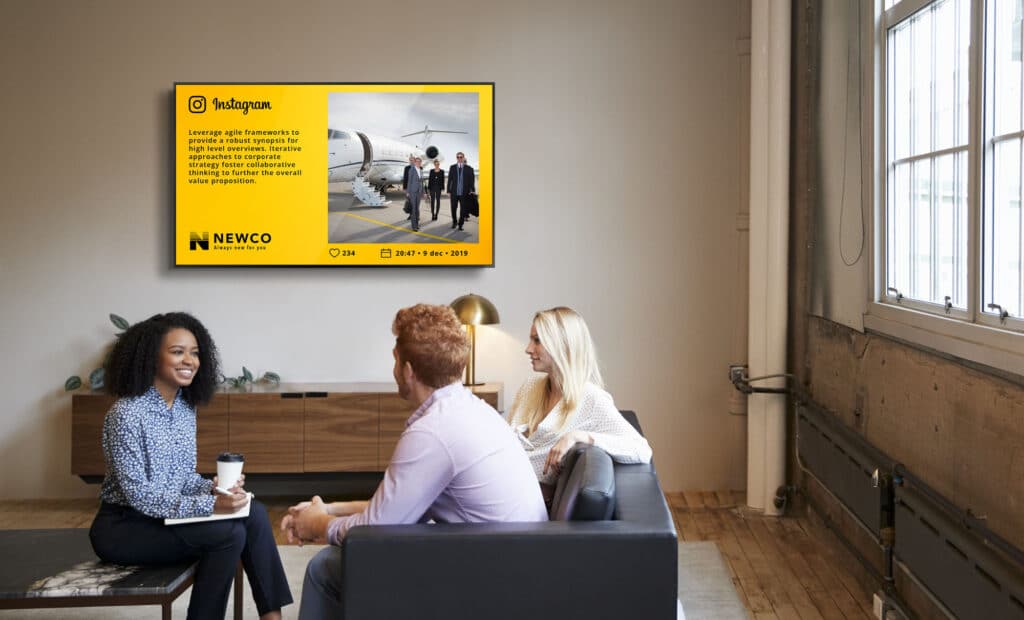 Three colleagues at a casual work meeting in a lounge area
